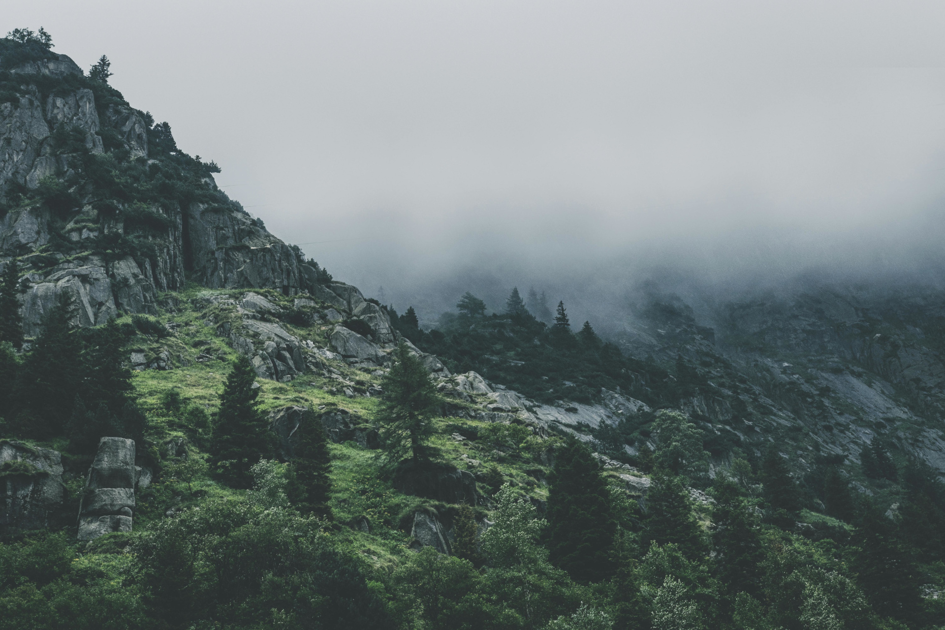 Symbolic background image with a foggy mountainous landscape.